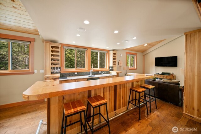 17650 Roaring Creek Rd, Leavenworth, WA 98826 - kitchen with light wood-type flooring, decorative backsplash, vaulted ceiling, and recessed lighting