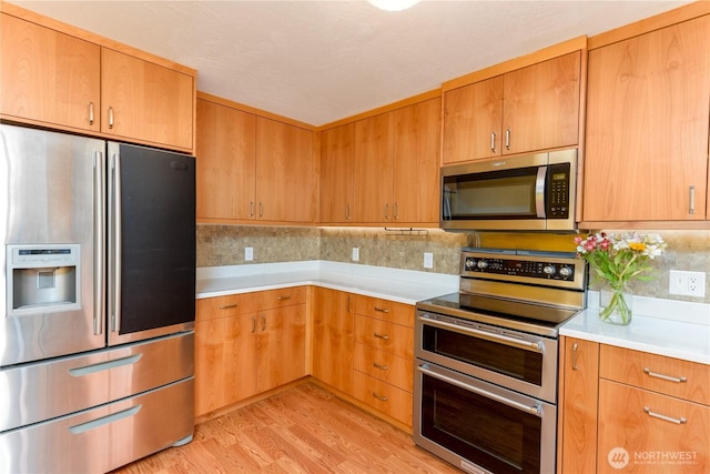 4109 S Reddick Rd, Port Angeles, WA 98363 - kitchen featuring stainless steel appliances, light countertops, light wood finished floors, and tasteful backsplash