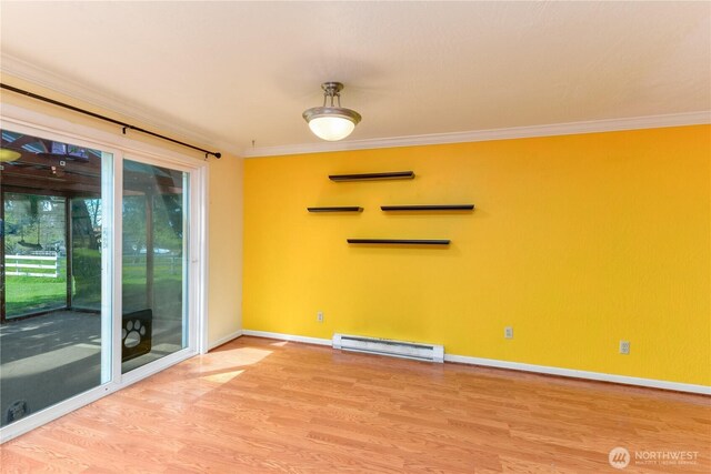 4109 S Reddick Rd, Port Angeles, WA 98363 - empty room with baseboard heating, wood finished floors, and crown molding