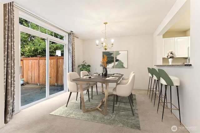carpeted dining area featuring an inviting chandelier