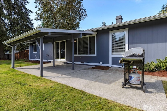rear view of property with a yard, a patio area, fence, and a chimney