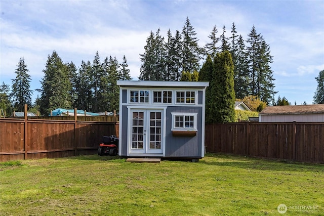 view of outdoor structure with a fenced backyard and an outdoor structure