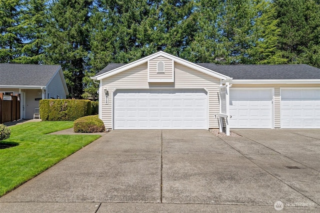 view of front of property with a garage, a front lawn, and concrete driveway