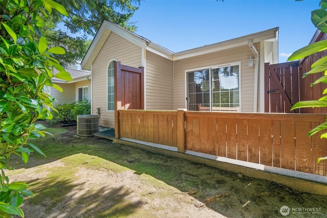 exterior space with fence and central AC
