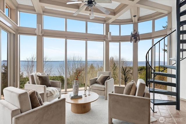sunroom with coffered ceiling, plenty of natural light, and a water view