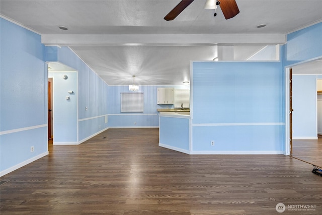 unfurnished living room with ceiling fan, baseboards, lofted ceiling with beams, and dark wood finished floors