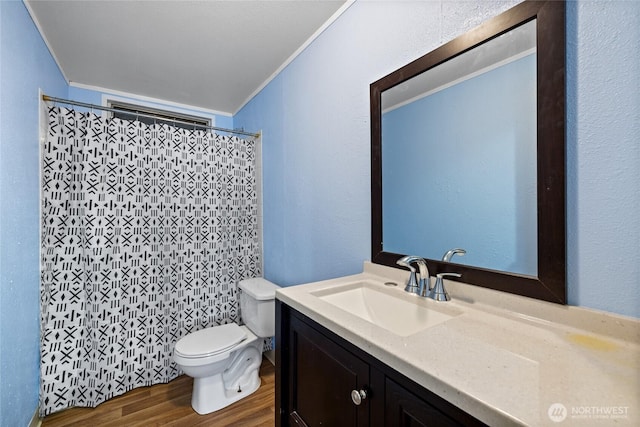 full bathroom with vanity, a shower with curtain, crown molding, toilet, and wood finished floors