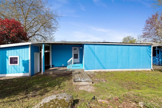 back of house with a lawn