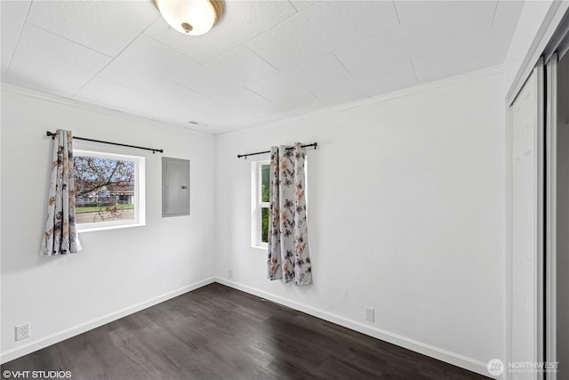 1210 Madison St, Aberdeen, WA 98520 - unfurnished bedroom featuring crown molding, dark wood-type flooring, a closet, electric panel, and baseboards