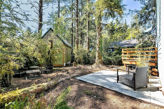 929 Discovery Ave SE, Ocean Shores, WA 98569 - view of yard featuring an outdoor structure and a wooden deck