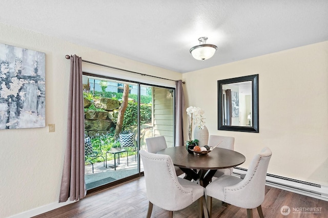 dining room with baseboards and wood finished floors