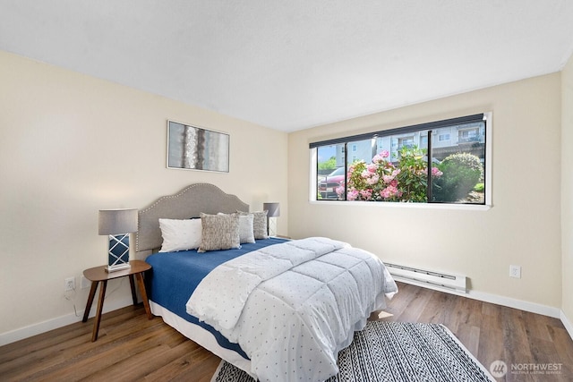 bedroom with a baseboard radiator, baseboards, and wood finished floors