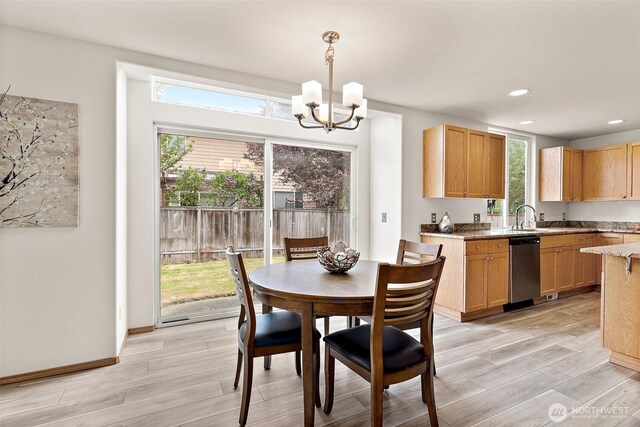 dining space with a chandelier, light wood finished floors, and recessed lighting
