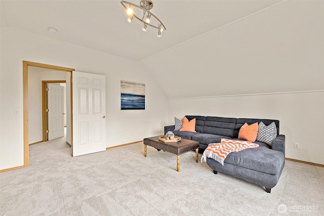 carpeted living room featuring vaulted ceiling, baseboards, and a chandelier