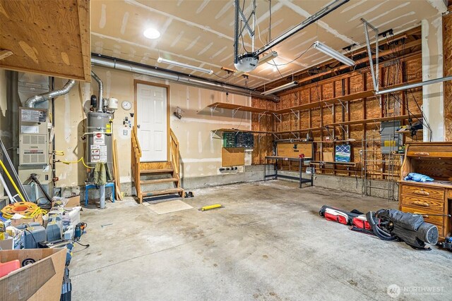 garage featuring a garage door opener and water heater