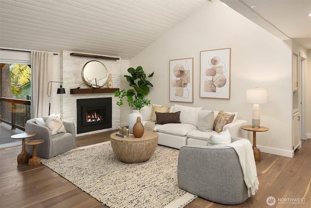 11820 NE 145th St, Kirkland, WA 98034 - living area featuring baseboards, vaulted ceiling, wood finished floors, and a large fireplace