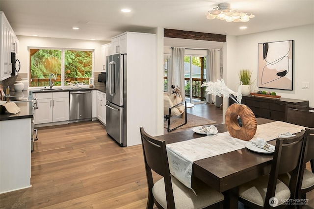 11820 NE 145th St, Kirkland, WA 98034 - dining area with recessed lighting, light wood finished floors, and an inviting chandelier