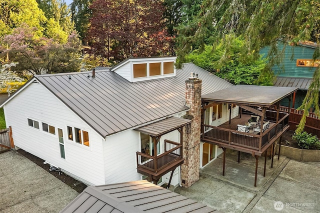 11820 NE 145th St, Kirkland, WA 98034 - back of property with a standing seam roof, metal roof, fence, a deck, and a patio