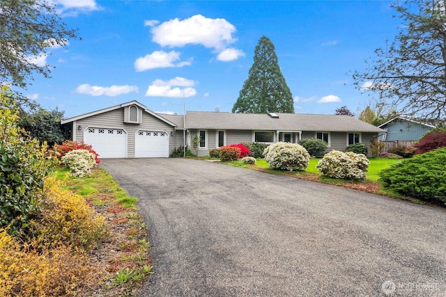 single story home with an attached garage and driveway