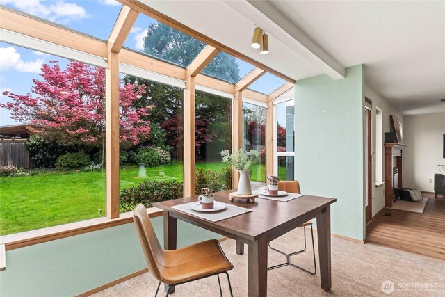 sunroom / solarium with baseboards and carpet floors