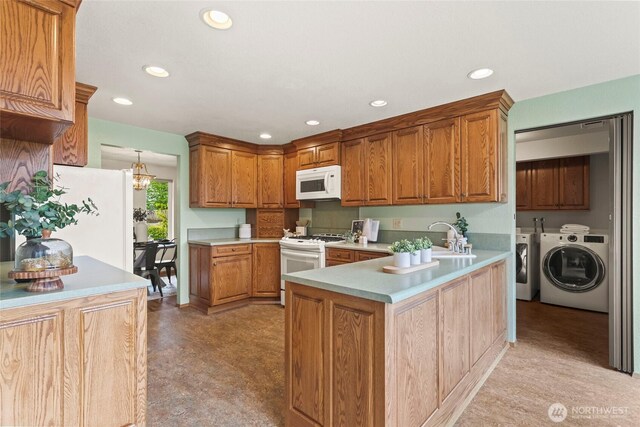 kitchen with recessed lighting, washer and clothes dryer, white appliances, and light countertops