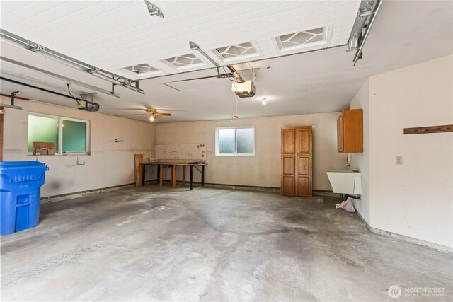 garage with a garage door opener and a sink