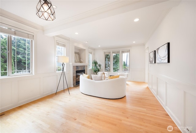 7018 117th Pl NE, Kirkland, WA 98033 - living room featuring a decorative wall, ornamental molding, a wainscoted wall, and a tile fireplace