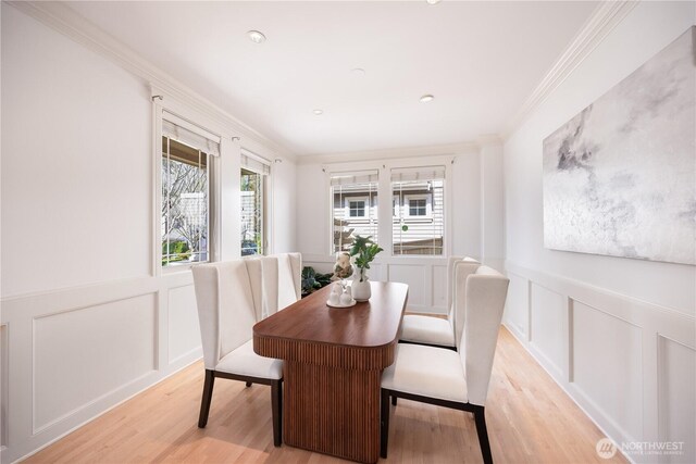 7018 117th Pl NE, Kirkland, WA 98033 - dining area featuring a decorative wall, light wood finished floors, wainscoting, and ornamental molding