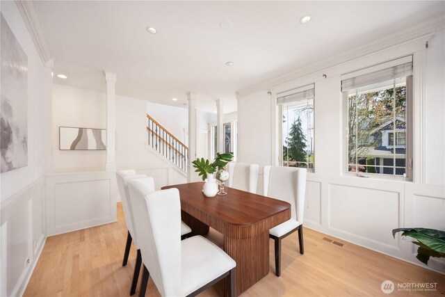 7018 117th Pl NE, Kirkland, WA 98033 - dining area featuring a decorative wall, visible vents, a wainscoted wall, and light wood-style floors