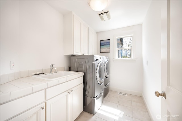 7018 117th Pl NE, Kirkland, WA 98033 - washroom with visible vents, washing machine and clothes dryer, a sink, and cabinet space