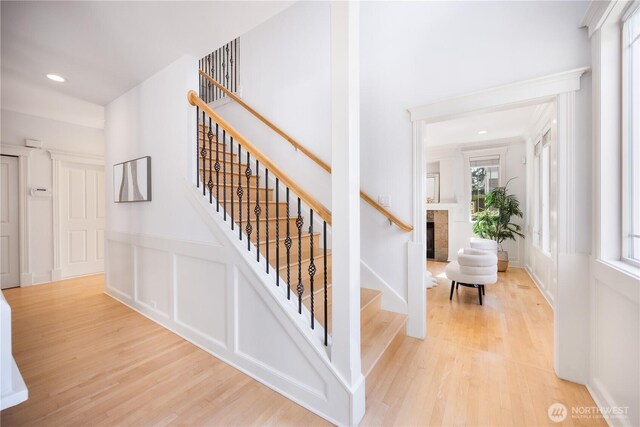7018 117th Pl NE, Kirkland, WA 98033 - stairway featuring plenty of natural light, a fireplace, and wood finished floors