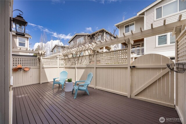 7018 117th Pl NE, Kirkland, WA 98033 - wooden terrace featuring a pergola, fence, and a gate