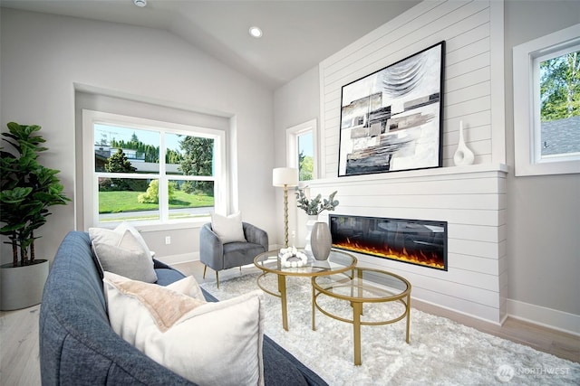 428 20th Ave, Kirkland, WA 98033 - living area with baseboards, a glass covered fireplace, lofted ceiling, wood finished floors, and recessed lighting