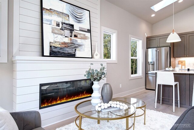 428 20th Ave, Kirkland, WA 98033 - living area with a skylight, light wood-type flooring, a large fireplace, lofted ceiling, and recessed lighting