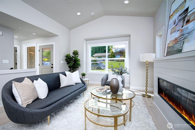 428 20th Ave, Kirkland, WA 98033 - living room featuring light wood finished floors, lofted ceiling, a glass covered fireplace, recessed lighting, and baseboards