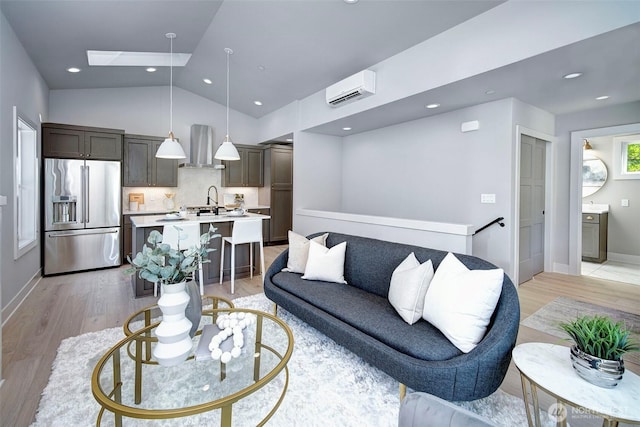 428 20th Ave, Kirkland, WA 98033 - living area featuring a wall mounted air conditioner, light wood-style flooring, baseboards, a skylight, and vaulted ceiling