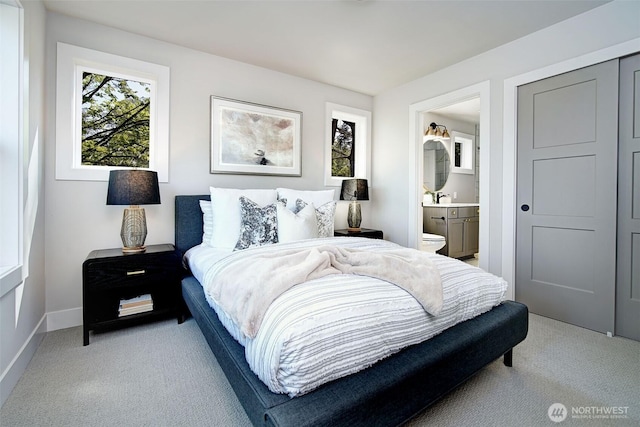 428 20th Ave, Kirkland, WA 98033 - bedroom with carpet floors, connected bathroom, baseboards, and a sink