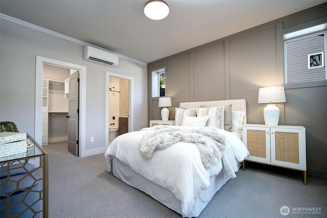 428 20th Ave, Kirkland, WA 98033 - carpeted bedroom with a wall mounted AC, ornamental molding, a spacious closet, baseboards, and a closet