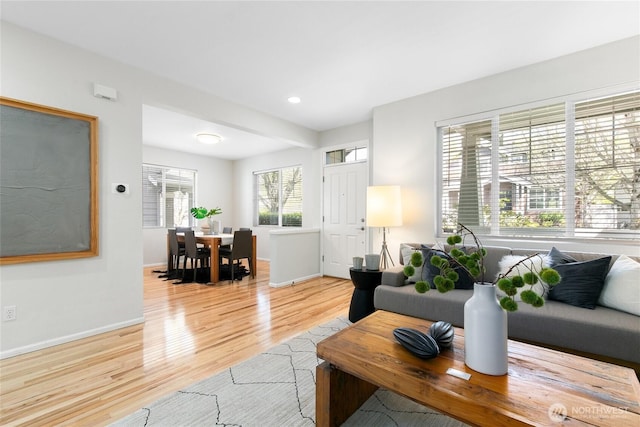 living area featuring recessed lighting, light wood finished floors, and baseboards
