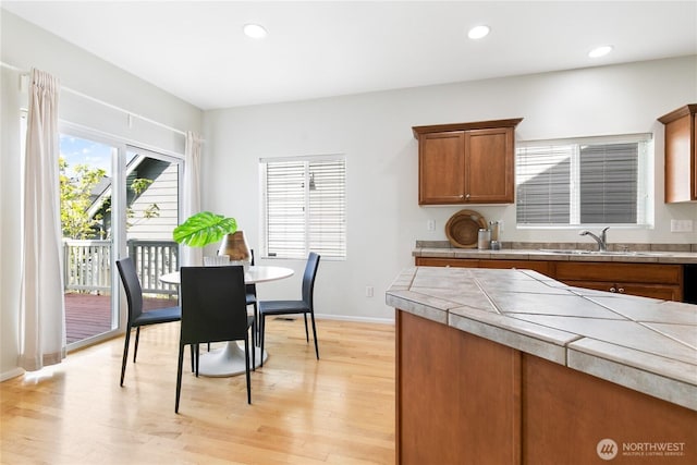 dining area featuring baseboards, recessed lighting, and light wood finished floors