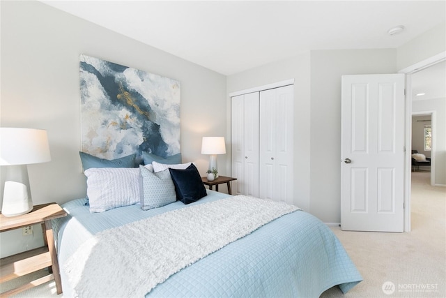 bedroom with a closet and light colored carpet