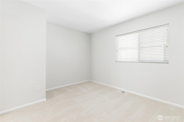 carpeted empty room with baseboards and visible vents