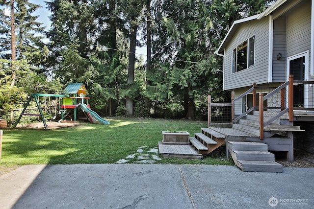 view of yard featuring a playground and a patio