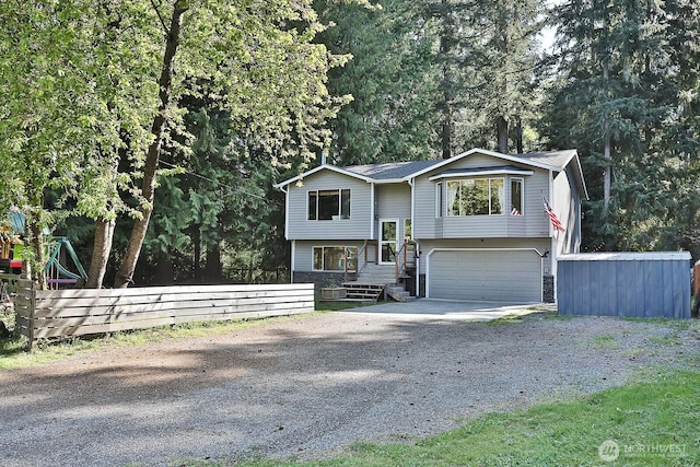 bi-level home with driveway and a garage