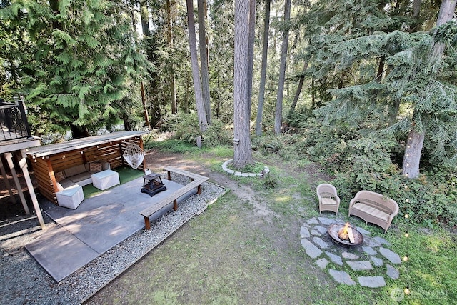 view of yard with a fire pit