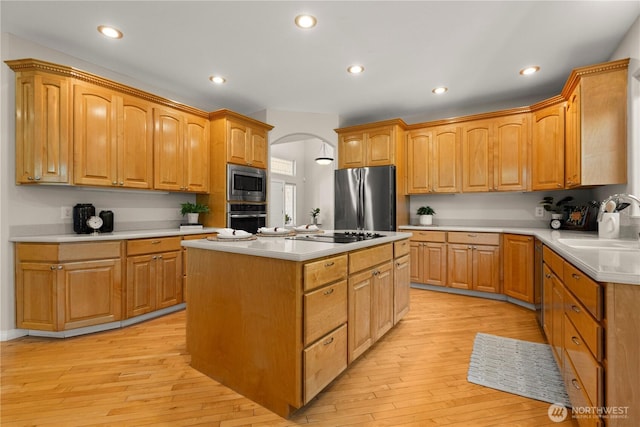 17605 244th Ave SE, Maple Valley, WA 98038 - kitchen featuring appliances with stainless steel finishes, a center island, a sink, light wood-style flooring, and recessed lighting