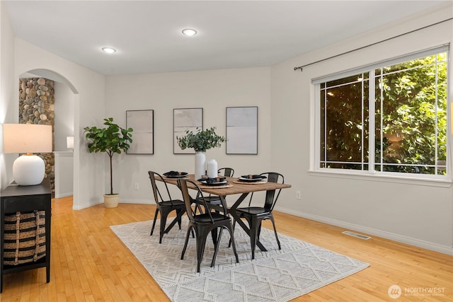 17605 244th Ave SE, Maple Valley, WA 98038 - dining space featuring wood finished floors, arched walkways, baseboards, and recessed lighting