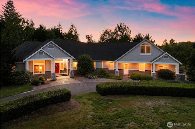 17605 244th Ave SE, Maple Valley, WA 98038 - craftsman house featuring a porch, central air condition unit, a front yard, and driveway