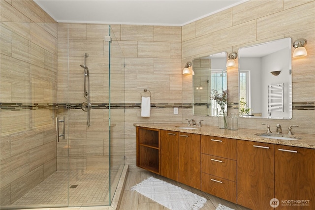 17605 244th Ave SE, Maple Valley, WA 98038 - bathroom with a shower stall, double vanity, radiator, a towel warmer, and tile walls