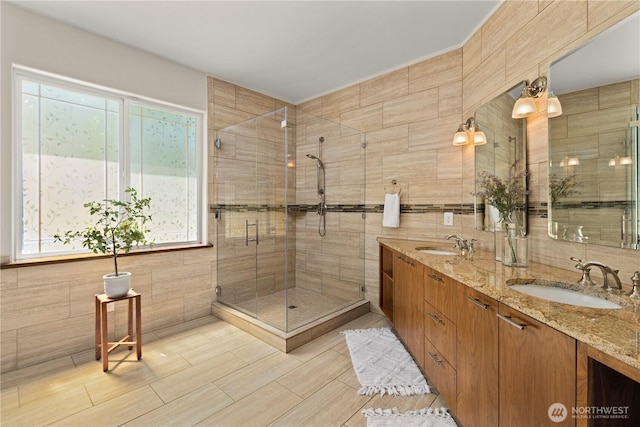 17605 244th Ave SE, Maple Valley, WA 98038 - full bathroom featuring tile walls, double vanity, and a shower stall